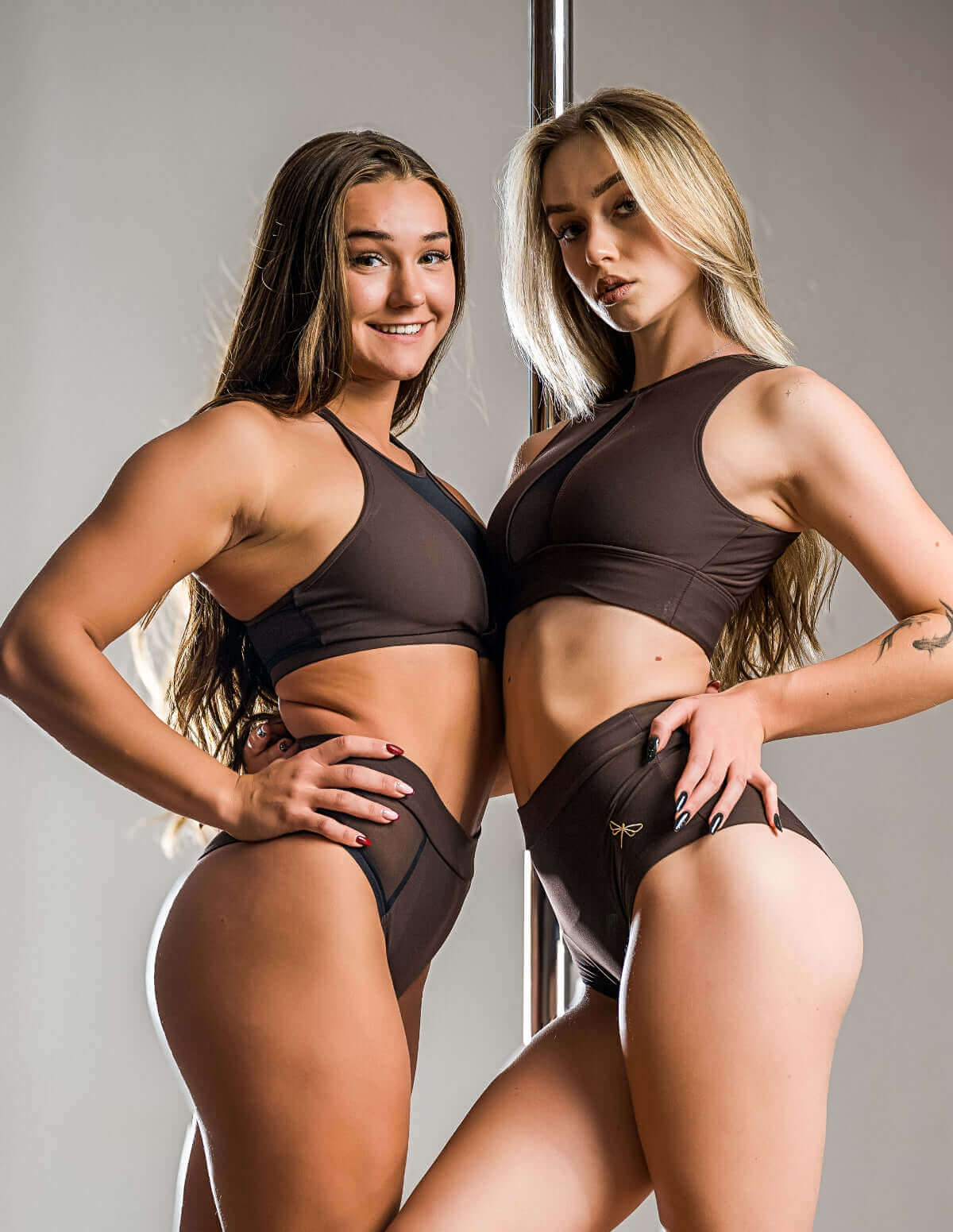 Two pole dancers wearing Scrunch bum pole shorts, high waist fit – Lola, posing creatively in a studio setting.